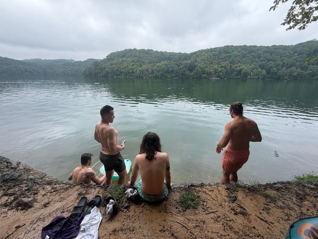 Friends at the edge of a lake on a gray summer day